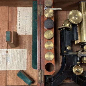 Antique brass microscope parts in a wooden case