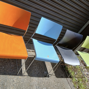 Orange and blue plastic chairs – set dressing