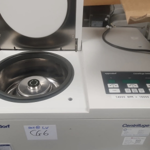 Benchtop centrifuge with lid open showing rotor