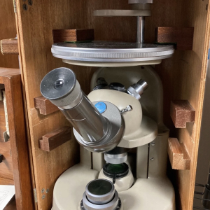 Vintage microscope in its wooden case – antique scientific prop