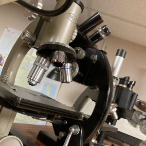 Close-up of a vintage black microscope – antique lab prop